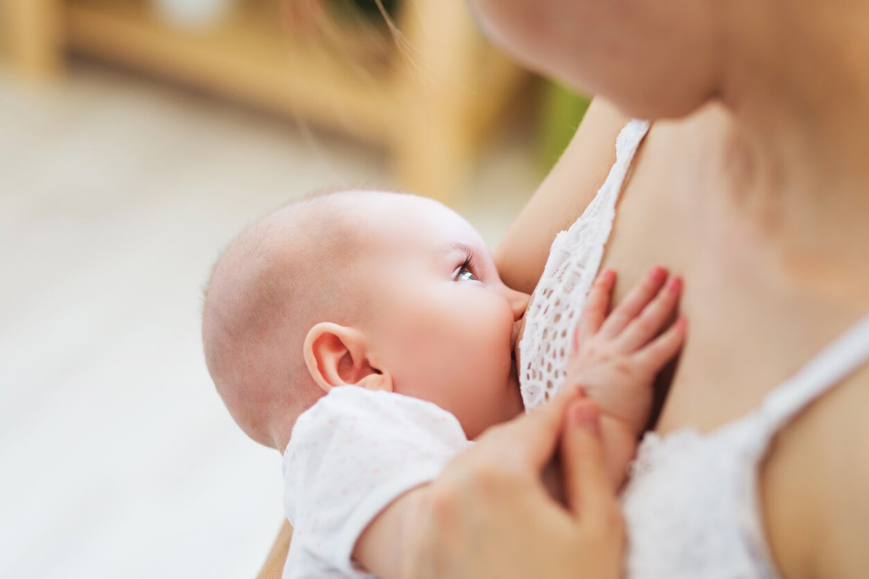 Young mom breast feeding her newborn child.