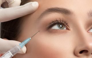 Beautician injecting liquid into human