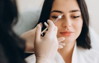 Young Woman Getting Botox Cosmetic Injection in Forehead