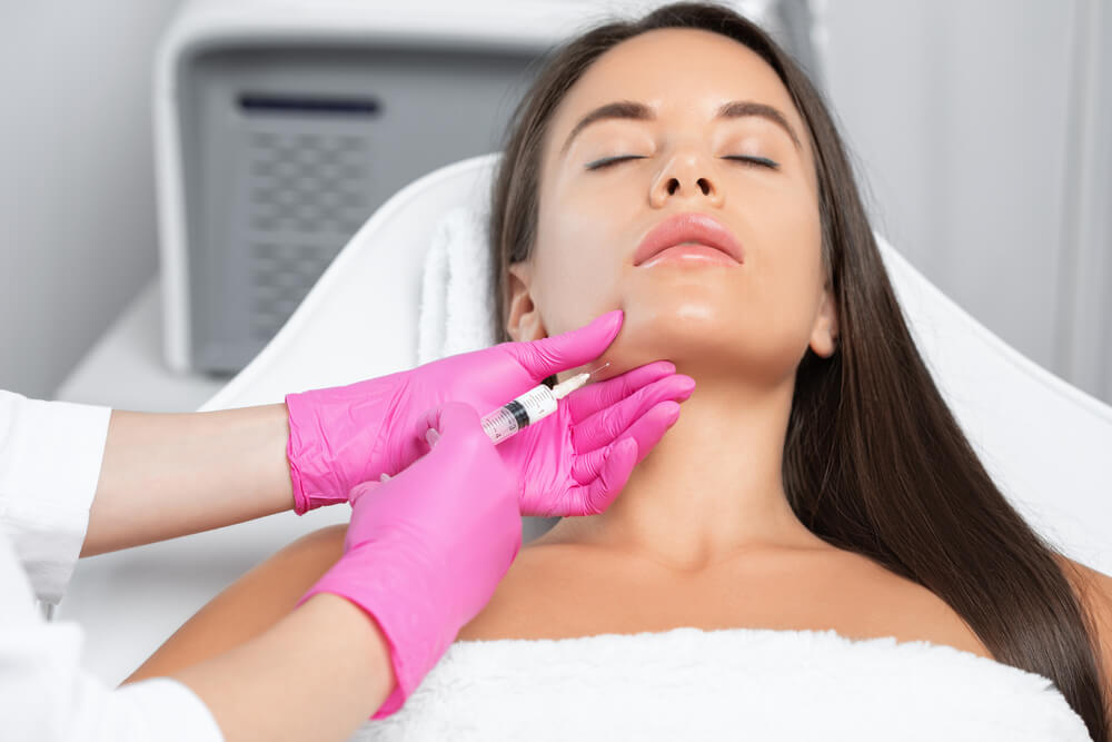 Cosmetologist Makes Lipolytic Injections to Burn Fat on the Chin, Cheeks and Neck of a Woman Against Double Chin.