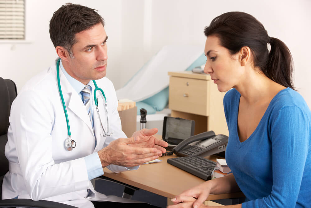 Doctor Talking to Woman About Skin Removal Surgery