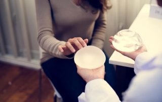 Woman Picking a Breast Implant
